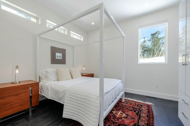 bedroom with multiple windows, baseboards, dark wood-style flooring, and recessed lighting