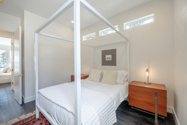 bedroom with wood finished floors and baseboards