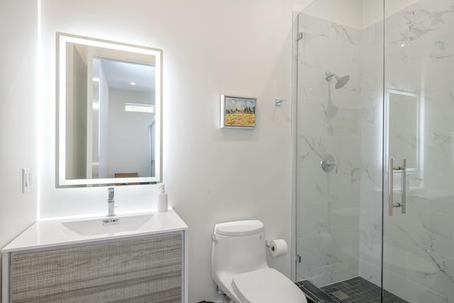 full bathroom featuring toilet, a marble finish shower, and vanity