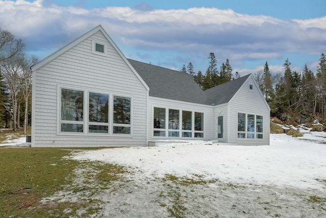 view of snow covered rear of property