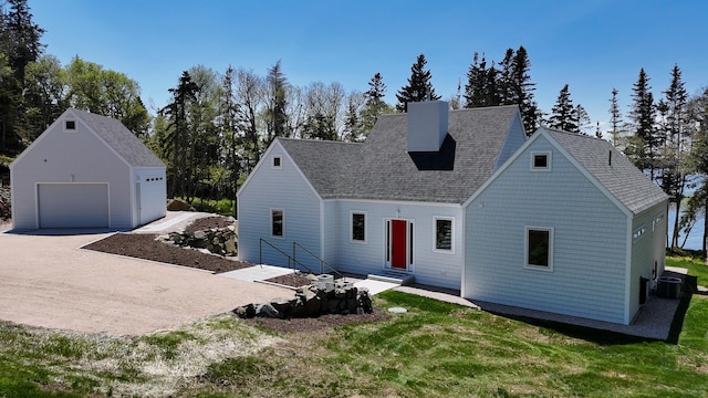 101 Cow Pt, Roque Bluffs, ME 04654 - view of front of home with roof with shingles, a garage, entry steps, a chimney, and cooling unit