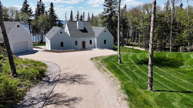 101 Cow Pt, Roque Bluffs, ME 04654 - view of front facade with curved driveway, a front lawn, and a shingled roof
