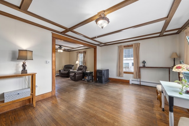 living room featuring baseboards, baseboard heating, wood-type flooring, and a healthy amount of sunlight