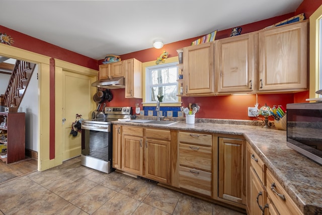 kitchen with light brown cabinets, under cabinet range hood, stainless steel appliances, a sink, and light countertops