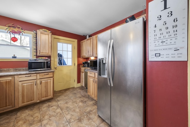 kitchen featuring appliances with stainless steel finishes and light tile patterned flooring