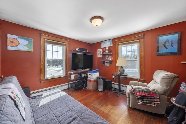 living area with a baseboard radiator and hardwood / wood-style flooring