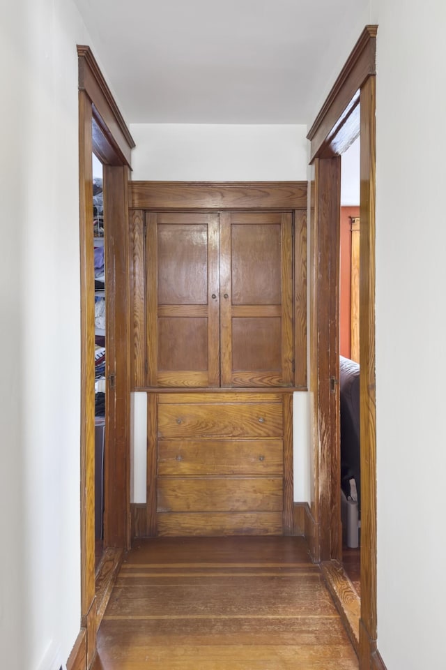 corridor featuring wood-type flooring