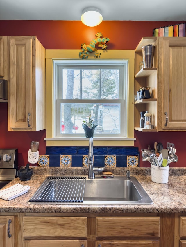 kitchen featuring light brown cabinets, open shelves, and a sink