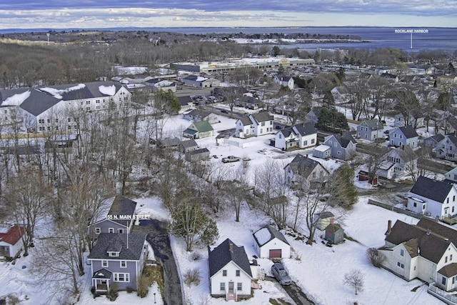 snowy aerial view with a residential view