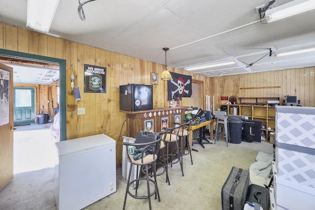 interior space with concrete flooring and wooden walls