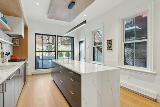 kitchen featuring light wood-type flooring, a center island, open shelves, and modern cabinets