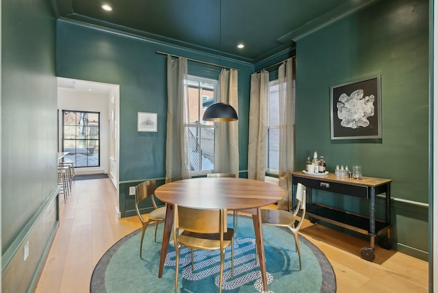 dining area with recessed lighting, crown molding, baseboards, and wood finished floors