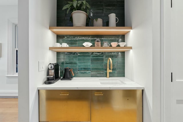 bar with tasteful backsplash and a sink