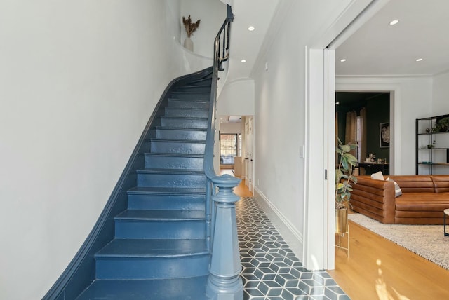 staircase with baseboards, crown molding, and recessed lighting