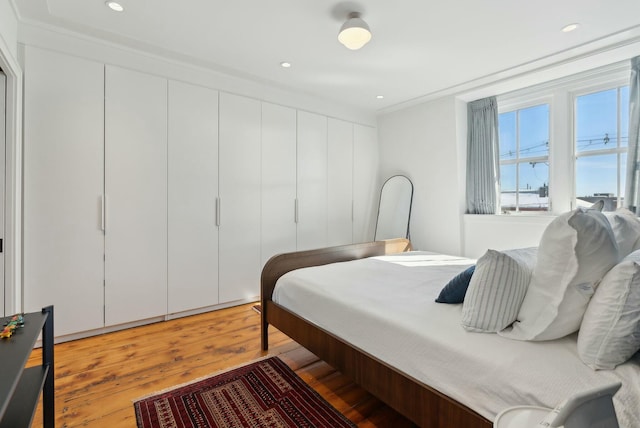 bedroom featuring light wood-style flooring and recessed lighting