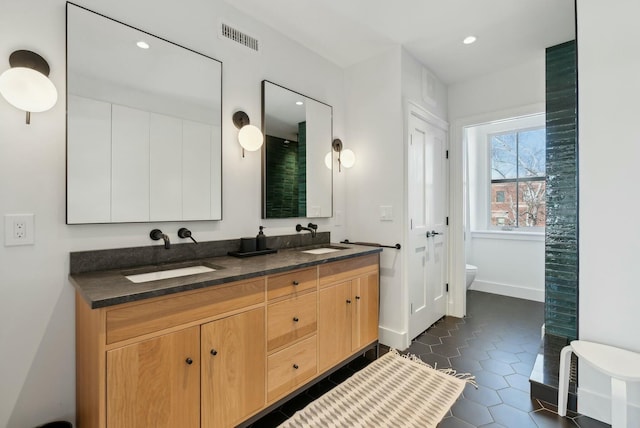 full bath featuring toilet, visible vents, a sink, and tile patterned floors