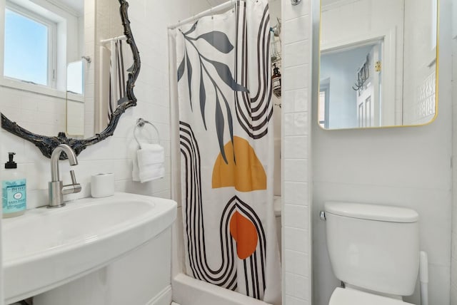 full bathroom with toilet, a sink, tile walls, and a shower with curtain