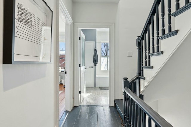 corridor with dark wood-style floors and stairs