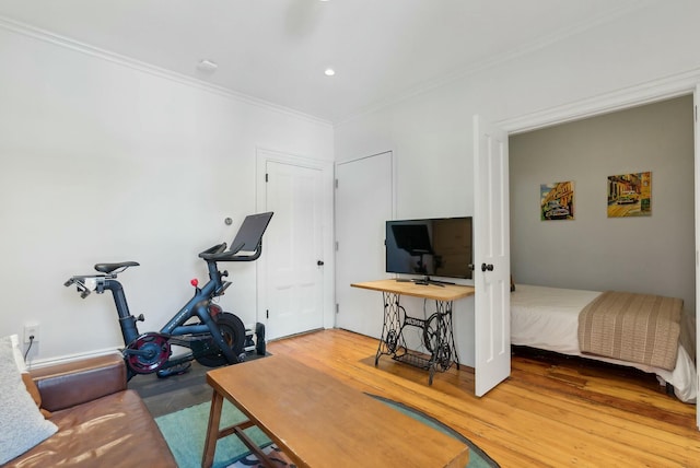 interior space with crown molding, wood finished floors, and recessed lighting