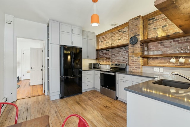 kitchen with stainless steel appliances, dark countertops, light wood-type flooring, and open shelves