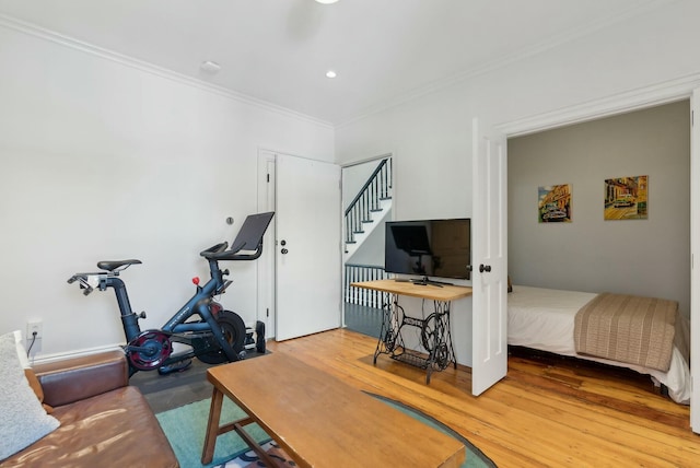 interior space with ornamental molding, wood finished floors, and recessed lighting