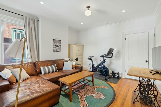 living room with ornamental molding, recessed lighting, and light wood-style floors