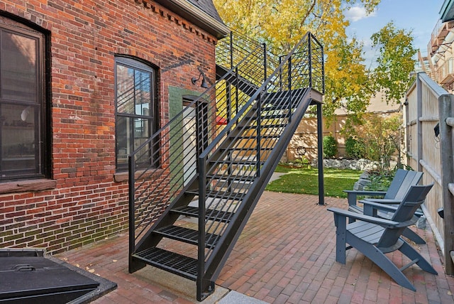 view of patio / terrace featuring stairs and fence