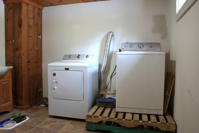 clothes washing area with washer and clothes dryer