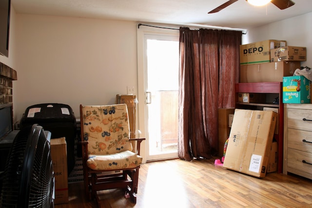 living area with ceiling fan and light wood finished floors