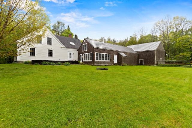 323 Runaround Pond Rd, Durham, ME 04222 - back of house featuring a lawn and a chimney