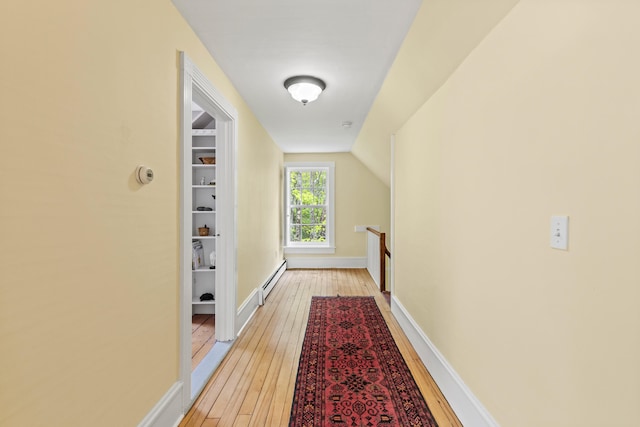 323 Runaround Pond Rd, Durham, ME 04222 - hallway featuring a baseboard radiator, light wood-style floors, an upstairs landing, and baseboards
