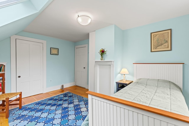 323 Runaround Pond Rd, Durham, ME 04222 - bedroom with wood finished floors, baseboards, and a skylight
