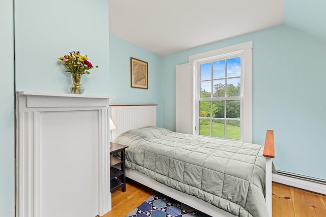 323 Runaround Pond Rd, Durham, ME 04222 - bedroom with wood finished floors, a baseboard radiator, and vaulted ceiling