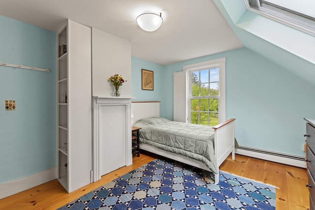 323 Runaround Pond Rd, Durham, ME 04222 - bedroom with baseboard heating and light wood finished floors