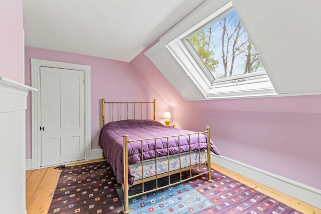 323 Runaround Pond Rd, Durham, ME 04222 - bedroom featuring hardwood / wood-style floors, vaulted ceiling, and a skylight