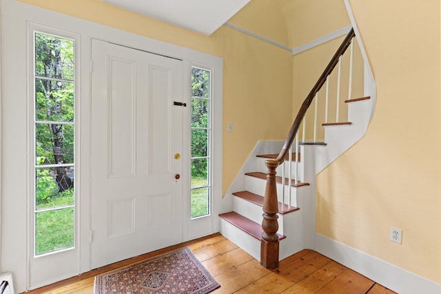 323 Runaround Pond Rd, Durham, ME 04222 - foyer entrance with light wood-style floors, baseboard heating, stairs, and baseboards
