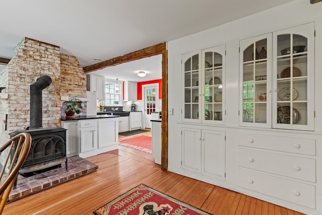 323 Runaround Pond Rd, Durham, ME 04222 - living area with a wood stove and light wood-style flooring