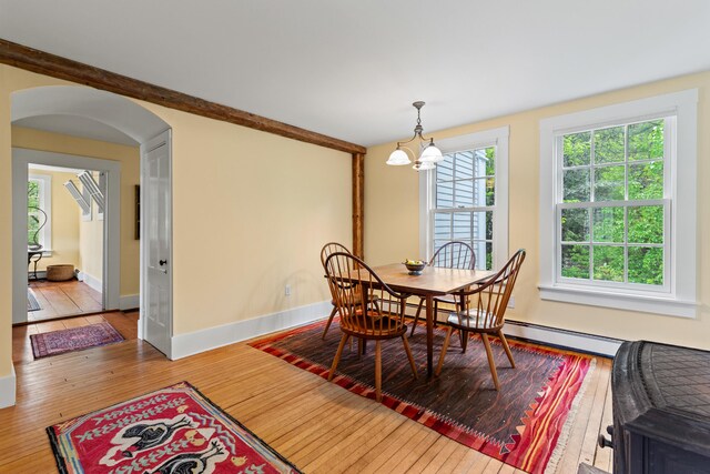 323 Runaround Pond Rd, Durham, ME 04222 - dining area with hardwood / wood-style flooring, arched walkways, a chandelier, baseboards, and baseboard heating