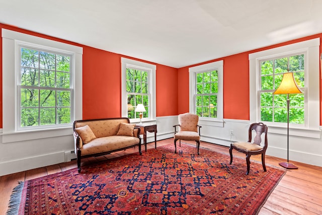 323 Runaround Pond Rd, Durham, ME 04222 - sitting room with wood finished floors and a baseboard heating unit