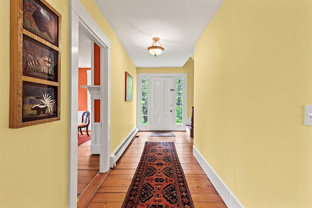 323 Runaround Pond Rd, Durham, ME 04222 - doorway with a baseboard radiator, light wood finished floors, and baseboards