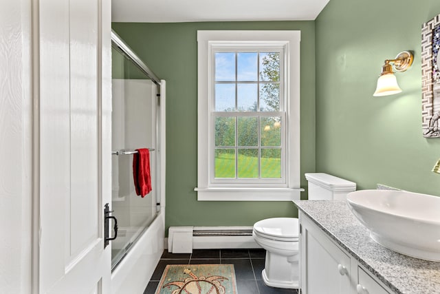 323 Runaround Pond Rd, Durham, ME 04222 - full bathroom with a baseboard heating unit, tile patterned floors, toilet, bath / shower combo with glass door, and vanity