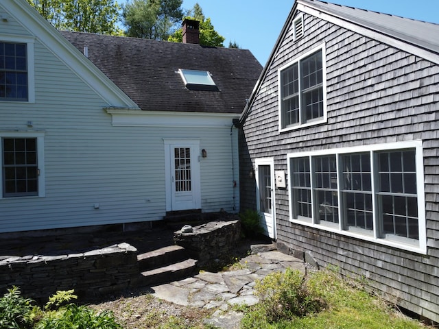 323 Runaround Pond Rd, Durham, ME 04222 - rear view of property featuring a chimney, entry steps, and a shingled roof