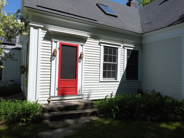 323 Runaround Pond Rd, Durham, ME 04222 - doorway to property featuring a shingled roof and a chimney