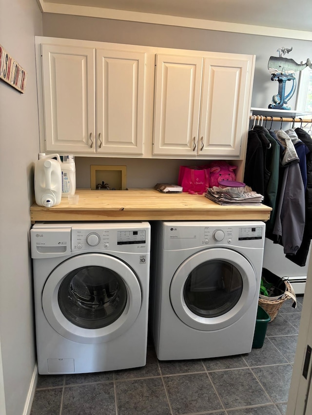 laundry room with washing machine and clothes dryer and cabinet space