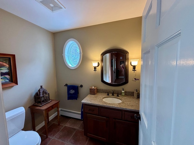 bathroom featuring tile patterned flooring, baseboards, toilet, baseboard heating, and vanity