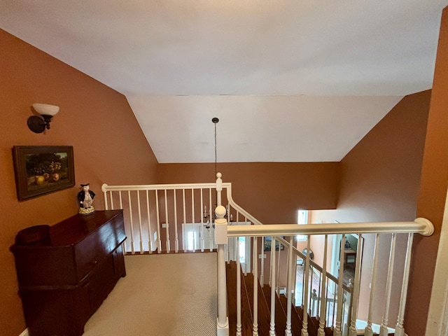 stairs featuring carpet and lofted ceiling