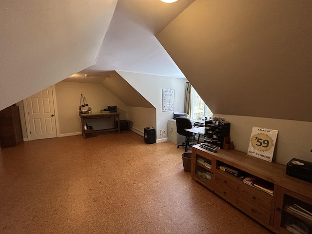 additional living space with a baseboard radiator, baseboards, and vaulted ceiling