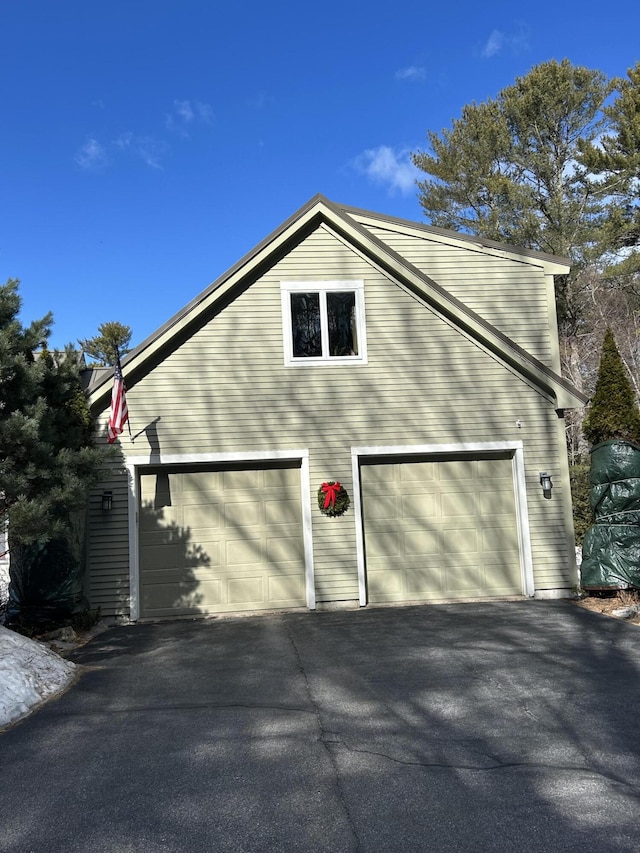 view of side of home featuring driveway