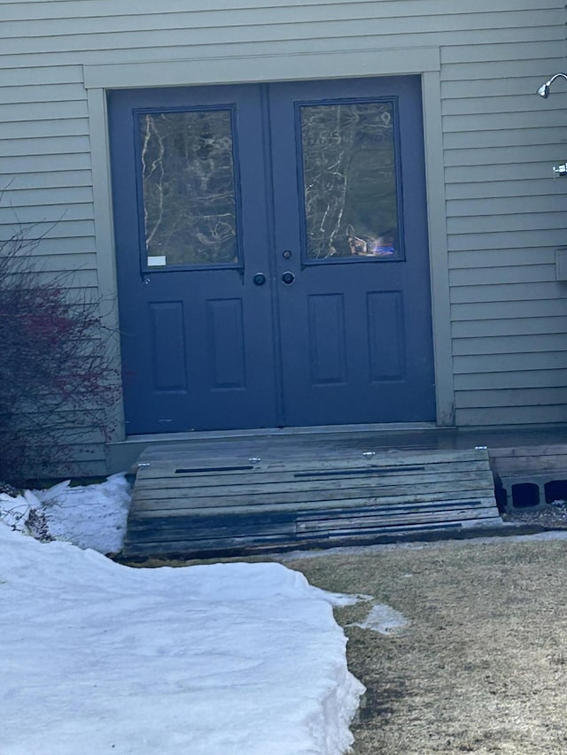 view of snow covered property entrance