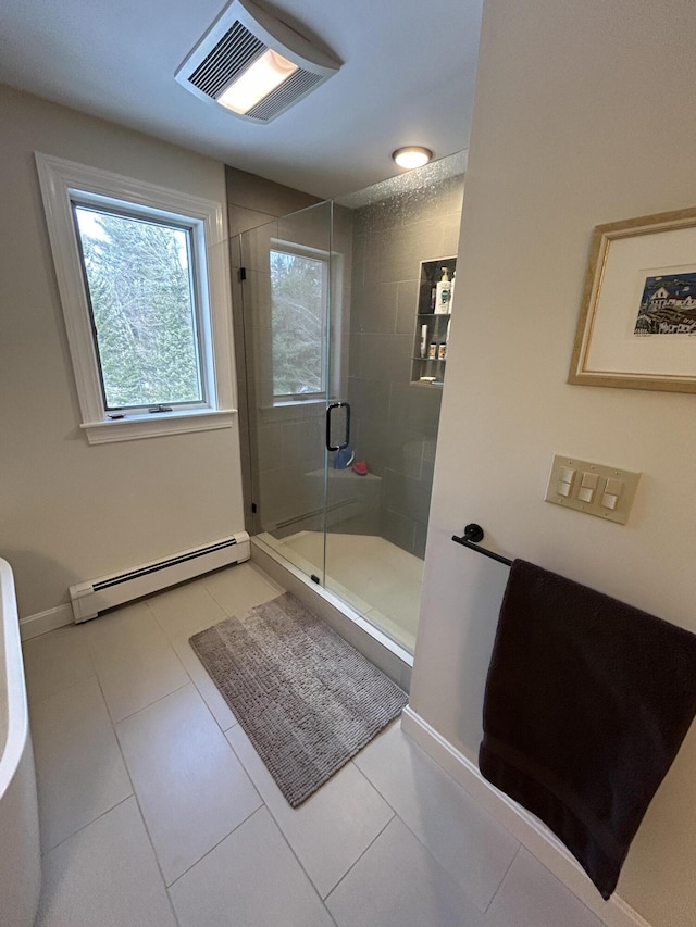 full bath with visible vents, a shower stall, baseboards, baseboard heating, and tile patterned floors